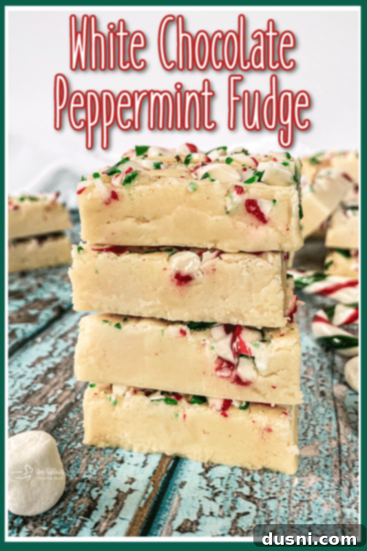A close-up of a white chocolate peppermint fudge square on a festive plate.