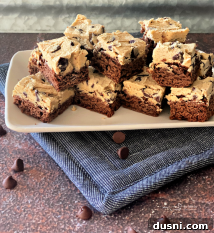 Cookie Dough Brownie Dream 15 Close-up of a cut Chocolate Chip Cookie Dough Brownie, showing the distinct layers.