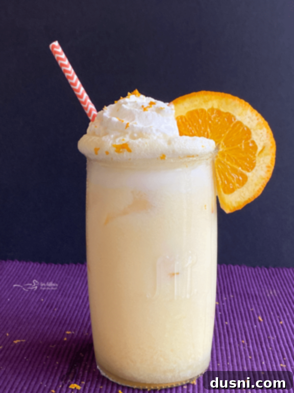 Grown Up Orange Julius cocktail with a purple background, a childhood favorite with a kick.