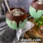 Side view of 2 grasshopper cocktails with a grey background