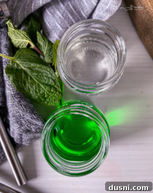 Adding vanilla ice cream to a blender, the first step for a creamy Grasshopper Cocktail.