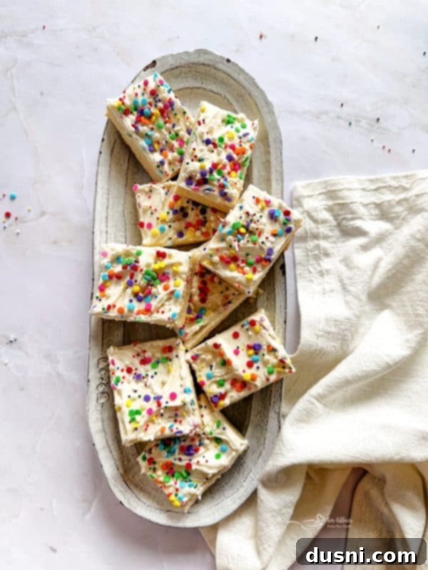 A perfectly sliced Frosted Sugar Cookie Bar, showing the thick frosting.