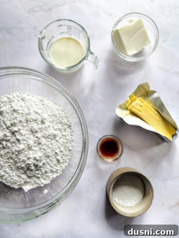 Ingredients for the sugar cookie base laid out, showing butter, eggs, sugar, and flour.