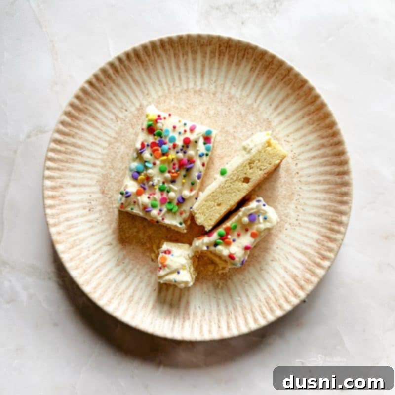 Top-down view of Frosted Sugar Cookie Bars with colorful sprinkles.