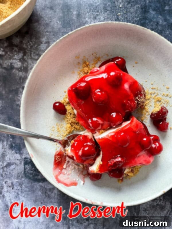 The finished no-bake cherry dessert, beautifully presented in a baking dish, ready to be served.