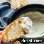 Close up of Slow cooker crab dip on a piece of toast