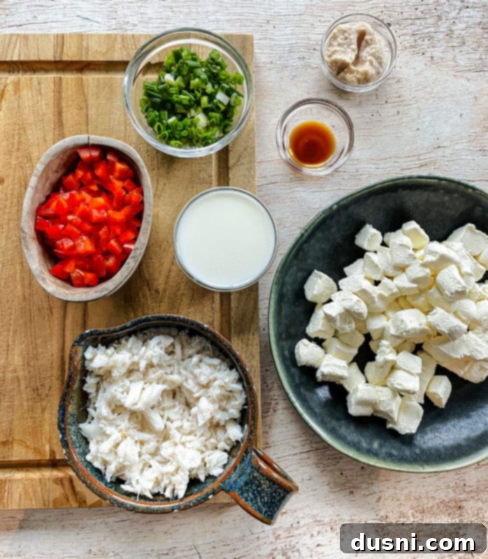A bowl of prepared horseradish and a spoon, emphasizing its use in the crab dip recipe.