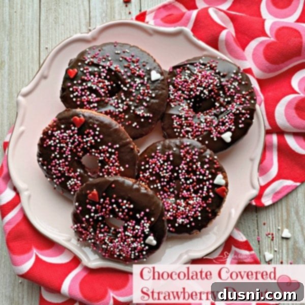 overhead of Baked Chocolate Covered Strawberry Donuts on a pink plate and text 