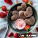 overhead of Chocolate Strawberry Whoopie Pies shaped like hearts in a green bowl