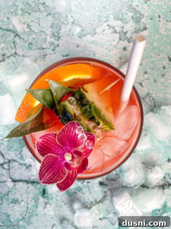 Radiant Island Fizz 3 A second view of the Tropical Sparkling Cocktail, highlighting its vibrant colors and inviting garnishes.