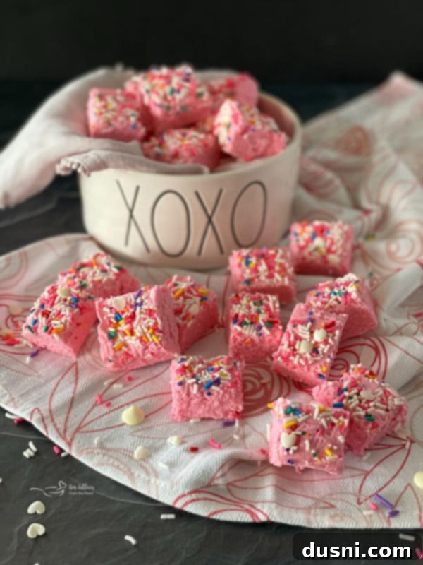 Velvet White Chocolate Cheesecake Fudge 3 Pink Valentine fudge squares in a serving dish
