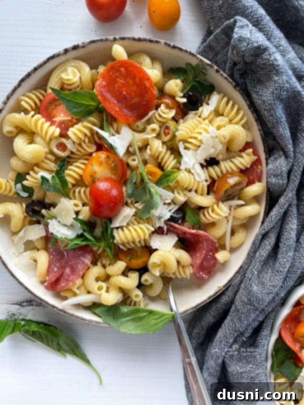 Italian Deli Pasta Salad 2 Top view of antipasto pasta salad in white bowl with fork