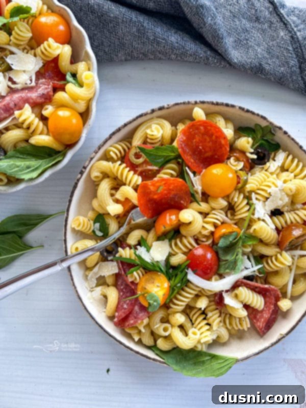 Italian Deli Pasta Salad 3 Two bowls of pasta salad with tomatoes and pepperoni
