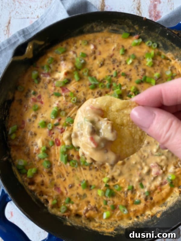 Golden Sausage & Cheese Fondue 8 Close up shot of the sausage cheese dip in a skillet