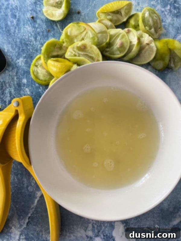 Zesty Key Lime Sheet Pie 6 Three key limes, one sliced in half, showing their yellow interior and small size compared to a whole lime.