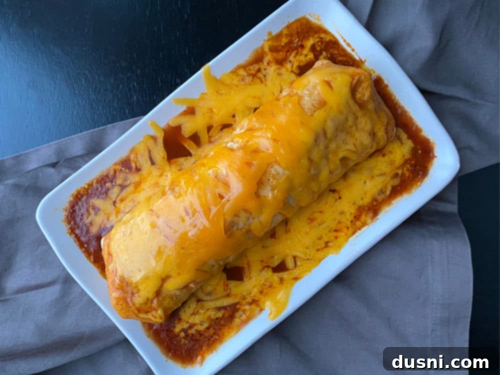 A freshly microwaved Taco Bell Enchirito, ready to be topped, with perfectly melted cheese.