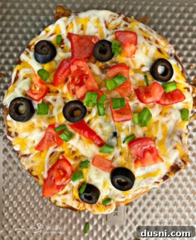 Overhead shot of a delicious copycat Taco Bell Mexican Pizza on a metal surface, emphasizing homemade quality.