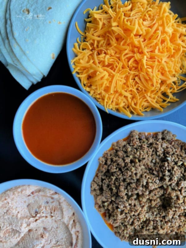 All the fresh ingredients laid out for making the Copycat Taco Bell Enchirito, including ground beef, tortillas, cheese, and sauces.