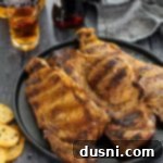 Jack Daniel's and Cola Glazed Steaks 16 Jack and Coke steaks on a plate with a shot of Jack and a bottle of Coke in the background.