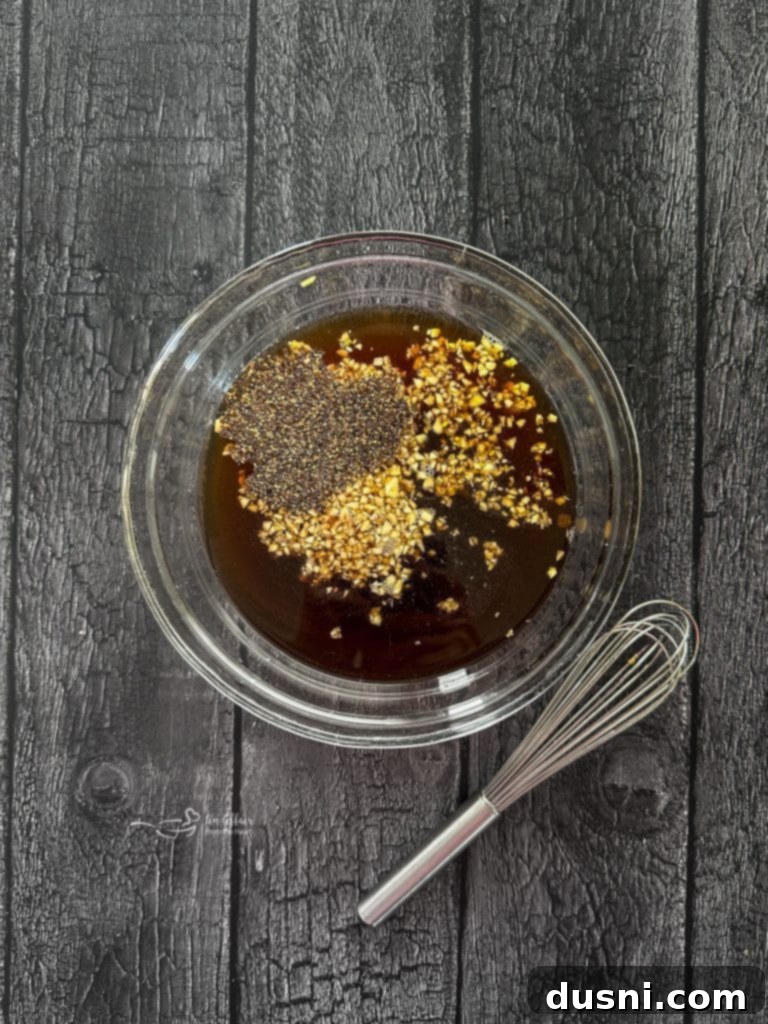 Jack Daniel's and Cola Glazed Steaks 7 Whisking together marinade ingredients in a bowl.