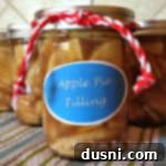 Side view of Homemade Apple Pie Filling in a glass jar, perfectly sealed.