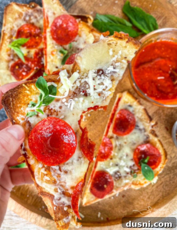 Pepperoni Pizza Grilled Cheese Melt 13 Two Pepperoni Pizza Grilled Cheese sandwiches on a board, with a side of tomato soup.