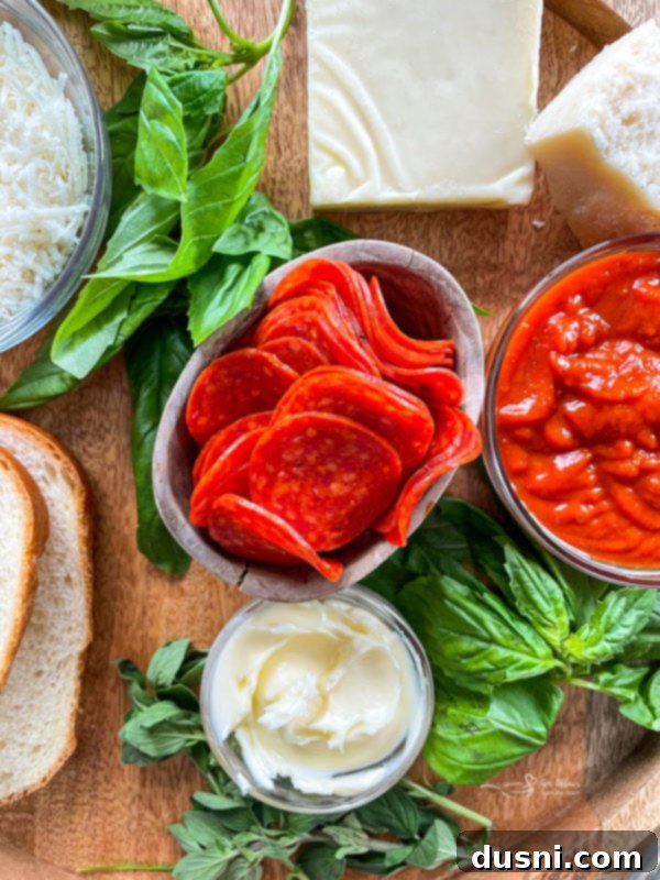 Pepperoni Pizza Grilled Cheese Melt 4 Top-down view of a pepperoni pizza grilled cheese sandwich, garnished with fresh basil leaves.