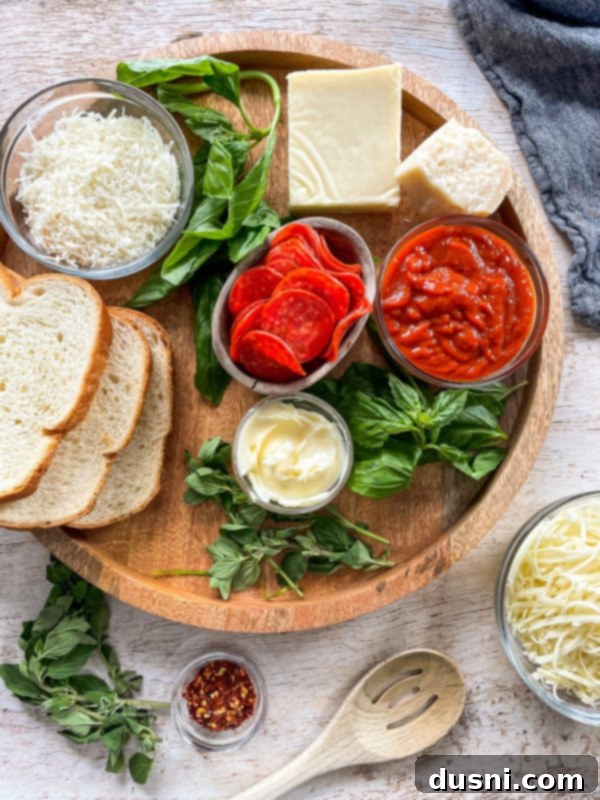 Pepperoni Pizza Grilled Cheese Melt 5 Four Pepperoni Pizza Grilled Cheese sandwiches arranged on a wooden board with a side of pizza sauce.