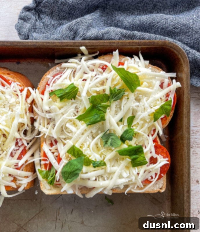 Pepperoni Pizza Grilled Cheese Melt 8 Pepperoni slices being added to pizza sauce on bread for grilled cheese.