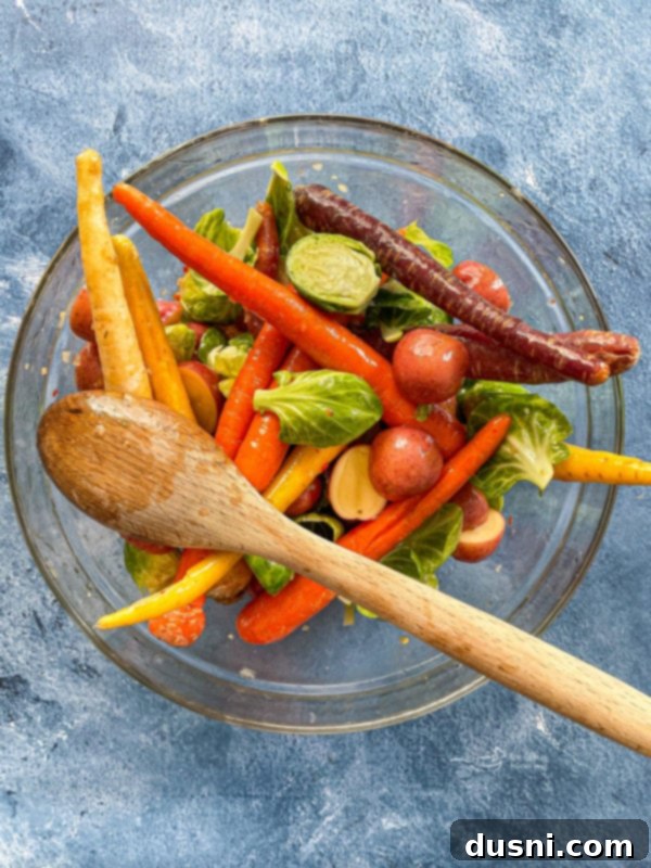 Carrots, potatoes, and Brussels sprouts in glass bowl with Italian dressing