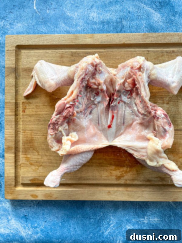 Spatchcocked chicken on cutting board
