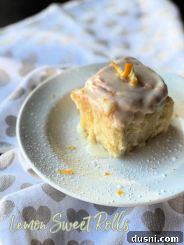 Front view of lemon sweet rolls on white plate