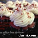 Side view of white chocolate cream cheese frosting on cupcakes, beautifully piped.