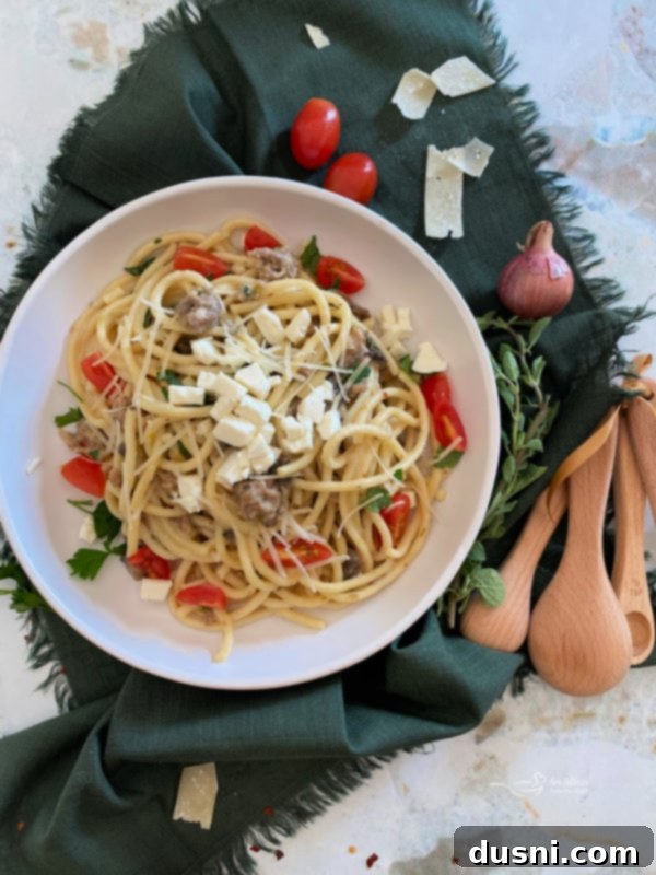 Top view of bucatini pasta with feta and tomatoes