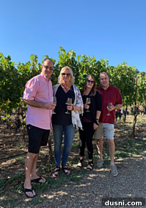 Four people standing in vineyard at Fontanella Winery