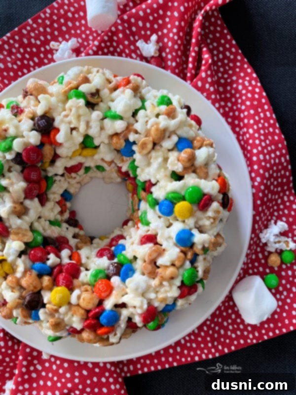 Close-up of a festive Popcorn Cake with M&M's and peanuts, perfect for celebrations.