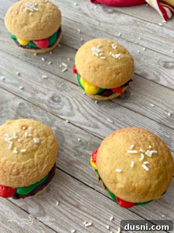 Hamburger Cupcakes with white jimmies sprinkled on top, mimicking sesame seeds.