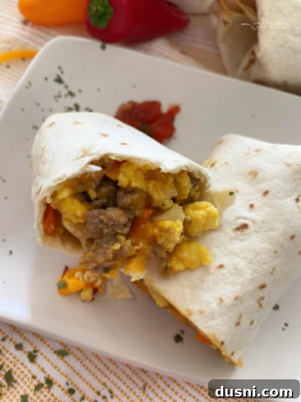Close-up of a breakfast burrito cut in half, showing the filling