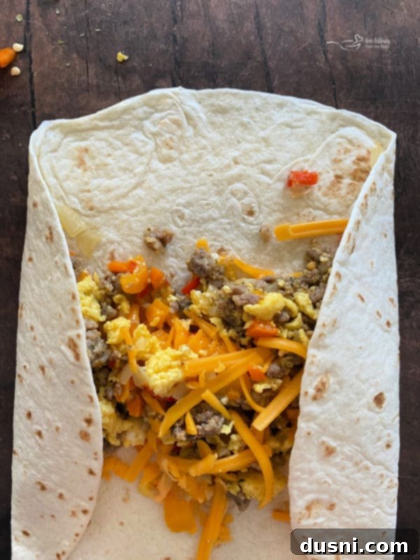 Scoop of filling on a tortilla with cheese