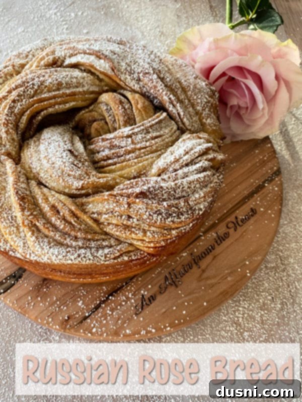 A freshly baked Russian Rose Bread with a beautiful golden crust, cut into a slice revealing the cinnamon swirl