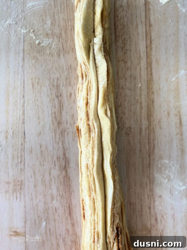 Step-by-step instruction showing cinnamon-sugar butter spread on dough and rolled into a log for Russian Rose Bread