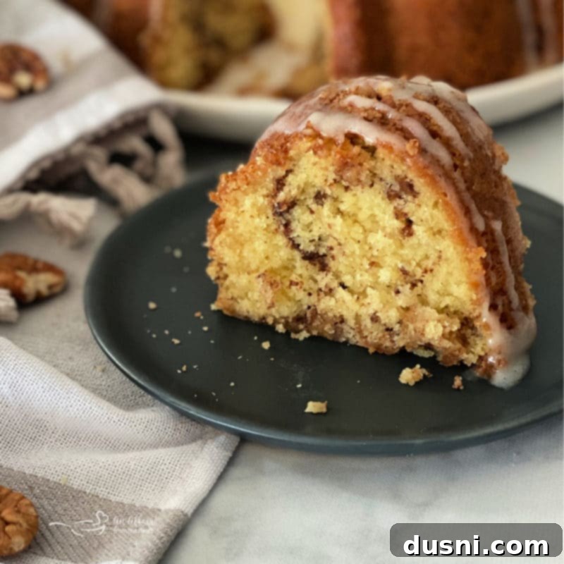 Close-up of a slice of sour cream coffee cake showing the streusel swirl