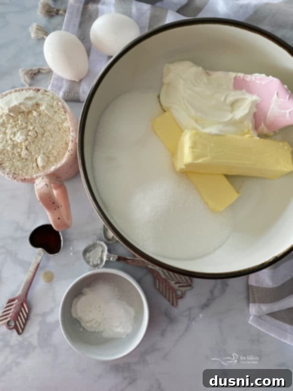 Bundt pan filled with sour cream coffee cake batter and streusel layers