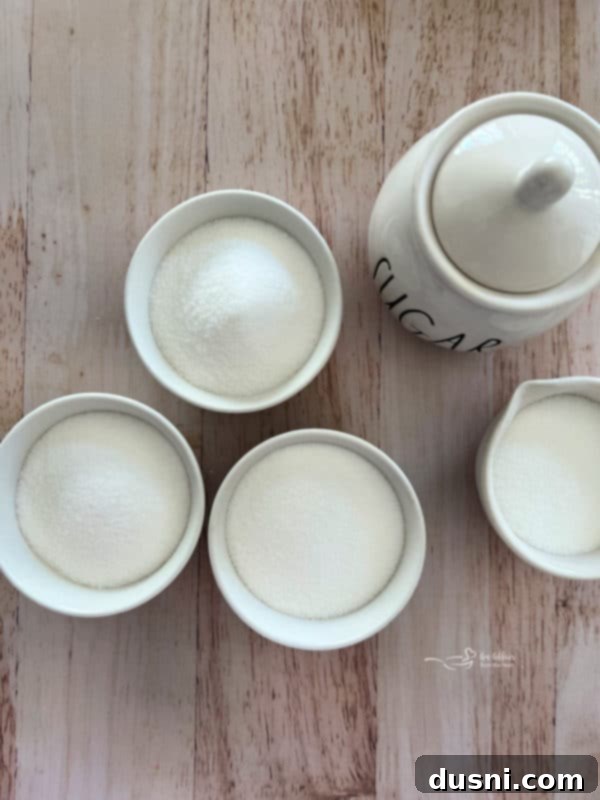 Ekstraktlarla Aromalı Şeker Yapımı 4 Close-up of various liquid extracts and flavorings, some in small bottles, others in tubes, showcasing the range of options for flavoring sugar.