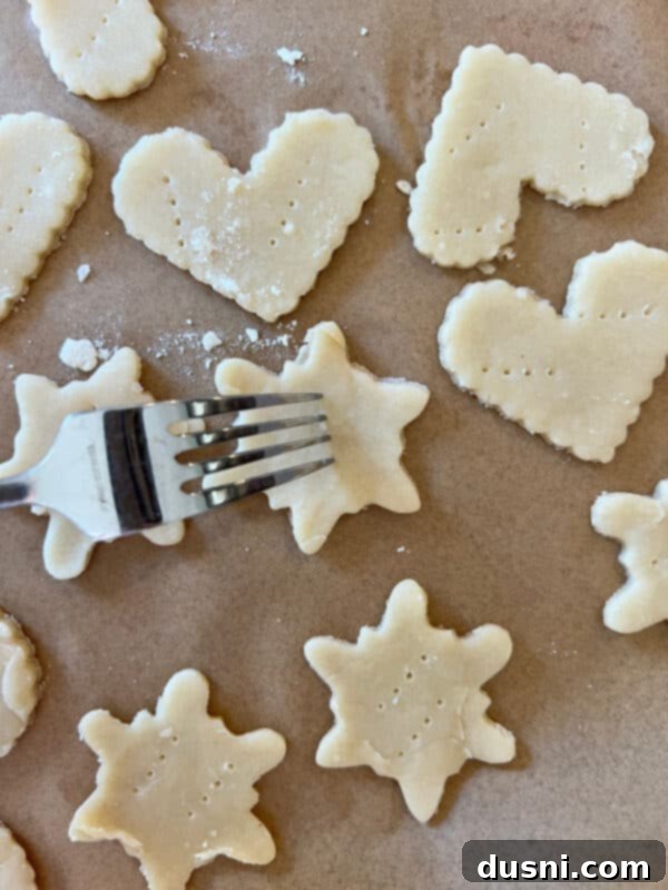 Using a star-shaped cookie cutter to cut out pie dough