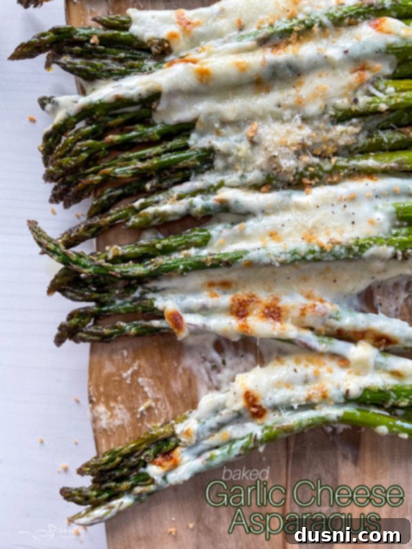 Top view of asparagus topped with melted cheeses