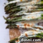 Top view of asparagus topped with melted cheeses