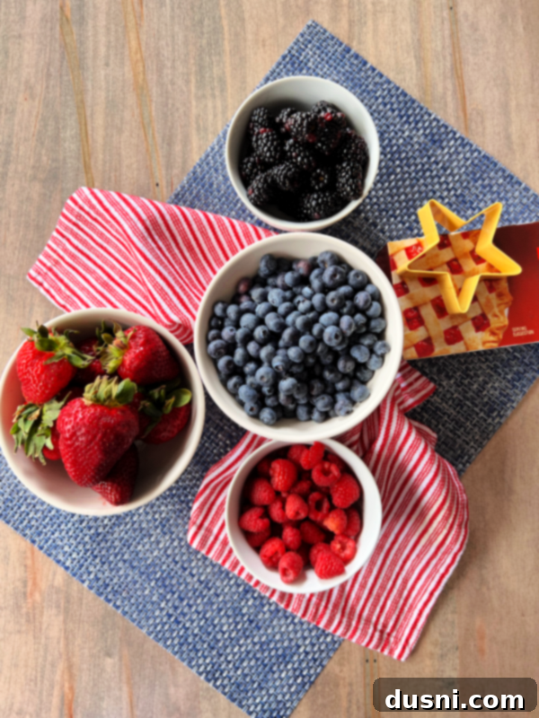 Culinary Anthem Remix 4 Deconstructed Patriotic Pie with various berries, whipped cream, and cookies in a clear bowl.