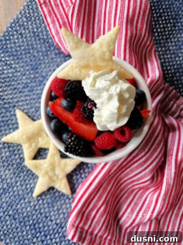 Culinary Anthem Remix 5 Deconstructed Patriotic Pie served in a bowl, showcasing layers of berries, whipped cream, and a pie crust cookie.