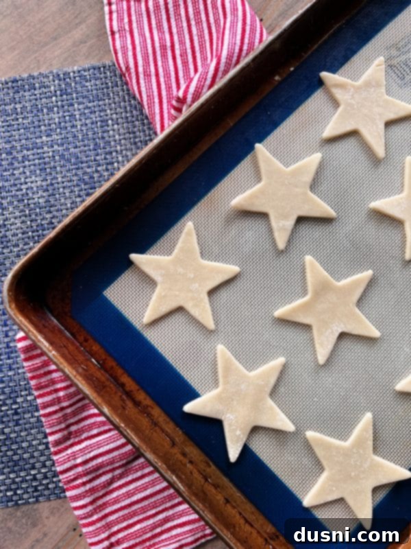 Culinary Anthem Remix 8 Whipped cream being added on top of a layer of fresh berries in a bowl.